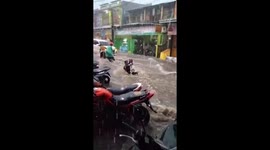 Dramatic moment Indonesian mother and daughter are almost swept away by flash floods