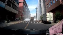 Water tank narrowly misses passing truck after falling from building in eastern China