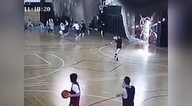 Basketball players flee as crane smashes through roof onto court in China