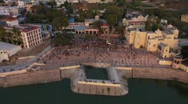 Pushkar lake in India at sunset. Drone footage of a crowd getting ready for sunset ceremony.
