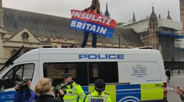 Insulate Britain protester climbs onto police van in Parliament Square