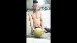 Vietnamese man uses his elbow to destroy a coconut