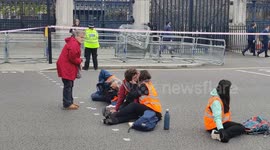 Insulate Britain protesters have a smooch as they are glued to the ground