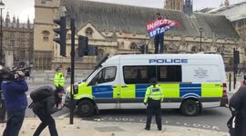 Insulate Britain activist climbs on police van outside Parliament