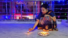 A Indian women celibrate Diwali by praying save the environment