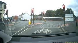 Idiot Driver nearly causing a crash jumping red light caught on dashcam