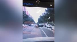Two men caught on camera stealing scooter rider's phone in central China