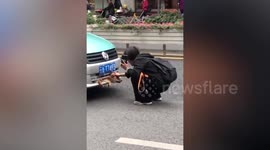 Pet dog stuck in bumper after being hit by taxi is rescued in China