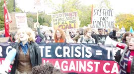 Smiling Large crowd of socialist protestors hold banners and signs and chant loudly at COP26 Protests at Glasgow 2021 United Kingdom
