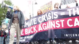 Low angle large crowd of socialist protestors hold banners and signs and chant loudly at COP26 Protests at Glasgow 2021 United Kingdom