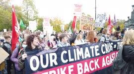 Passionate large crowd of socialist protestors hold banners and signs and chant loudly at COP26 Protests at Glasgow 2021 United Kingdom