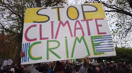 Crazy passionate single socialist protestor holds banner at COP26 Protests at Glasgow 2021 United Kingdom