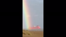 Amazing Big red ship going though a double rainbow in the uk