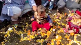 Locals dip their young ones in cow dung in central India