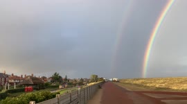 Amazing double rainbow arching from the Waterways to the sea
