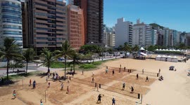 A sunny day at Praia da Costa beach in Vila Velha  showing peaple enjoy the day and playng tennis - BRAZIL