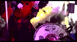 Two old ladies in halloween day of the dead costumes at the Hollywood Forever Cemetery waving old hand fans