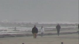 President of the United States Joe Biden and First Lady of the United States Jill Biden walk on the beach at Cape Henlopen State Park in Delaware on November 7, 2021