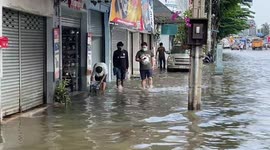 Homes flooded road after Bangkok river overflows following rainstorm