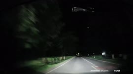 Meteor lights up the night sky in front of motorists in Thailand