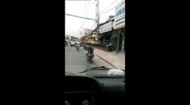 The man used his shoulder to carry dozens of six-meter-long iron pipes moving by motorbike on a crowded street in Vietnam
