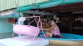 Baby rocked to sleep on floating hammock in the middle of flood
