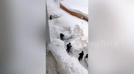 Residents dig out parked cars buried under heavy snow in northern China