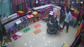 Pregnant woman and others escape unscathed as MOTORCYCLE crashes through garment shop in India