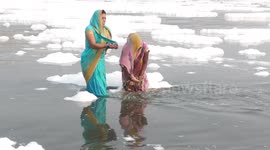 Toxic foam in holy river doesn't stop devotee women from taking a dip