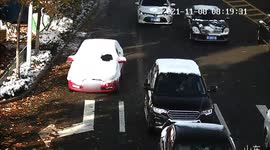Police stop snow-covered car from driving along road in China