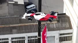 Replica McLaren driven by Brazilian F1 legend Ayrton Senna hangs above Sao Paulo