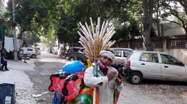 A local Street Vendor playing a melodious song while selling flute.