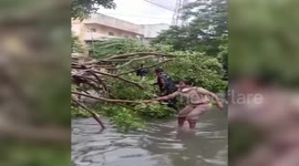 Female police official carries unconscious man to safety amid flash floods in southern India