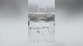 Art students make giant snow mural after blizzard in China