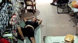Rat climbs on man's belly when he was taking a nap in shop in China