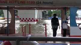Locals prepare for high tide floods at Taksin Pier in Bangkok, Thailand