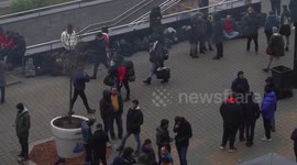 In Minsk, migrants climb into taxis taking them to the border as Belarus police watch on