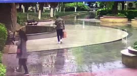 Chinese man glued to his phone walks straight into water pool
