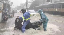 Traffic struggles against torrential floods in Indonesia city streets