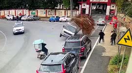 Speeding truck flips round corner dumping cargo of planks in southern China