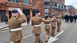 Armed Forces parade along a main road in Leeds City Centre  on Remembrance Sunday