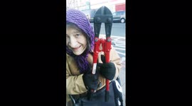 Elderly lady wheeling bolt cutters on her wheelchair in London. She is asked what she intends to use them for.