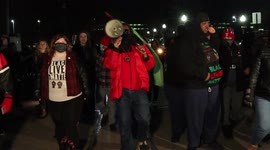 Justin Blake take the group of protesters on a walk around the courthouse chanting