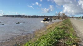 Farmers using tractors to save cattle and livestock from the floods in Abbotsford, BC Canada