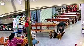 Father's quick reactions catch son mid-air as he falls from bench at Chinese restaurant