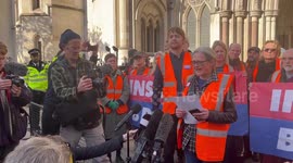 Tracey Mallaghan from Insulate Britain reads a statement outside the Royal Courts of Justice on behalf of the nine imprisoned members of the group, London, England, UK