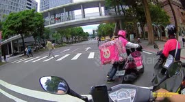 WTF MOMENT: Delivery driver gets off moped and walks through red light to bypass it (Dashcam Video)