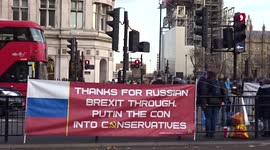 Pro-EU protesters rally outside Parliament with 'Thanks for Russian Brexit through.  Putin the con into Conservatives' banner