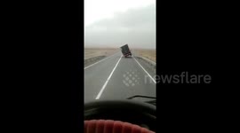 Powerful winds topple over truck on highway in Kazakhstan