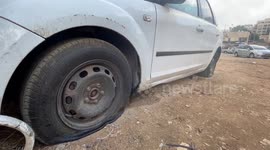 Palestinians inspect their vehicles after Israeli settlers 'slashed tires'
